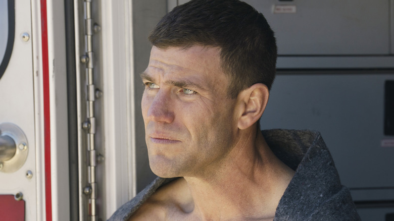 Gibbs stares into the distance while being treated in an ambulance in 