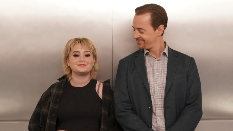 Timothy McGee smiling at Teagan Fields in an elevator