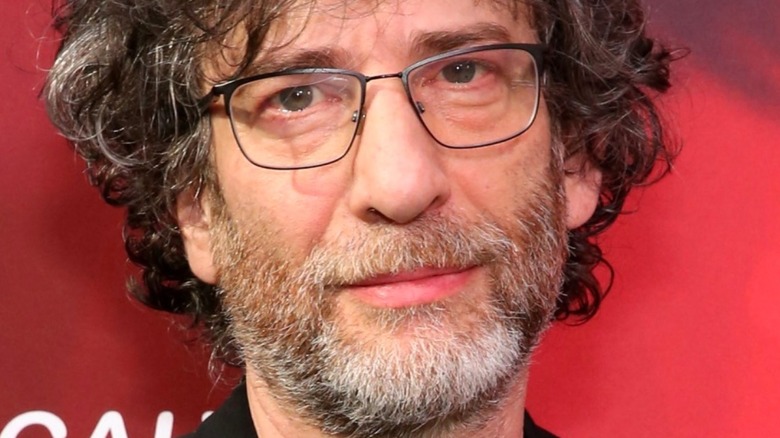 Neil Gaiman with a beard with glasses