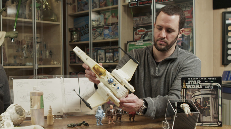 A man holds a vintage X-wing Star Wars toy in The Toys that Made Us (2017)
