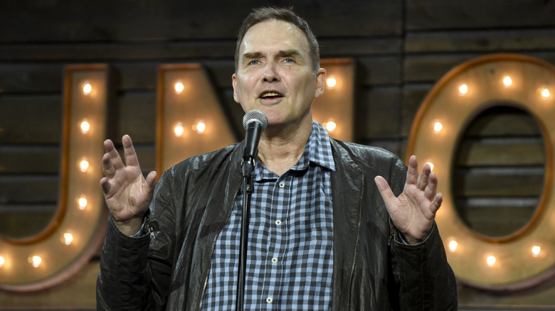 Norm Macdonald speaking into a microphone
