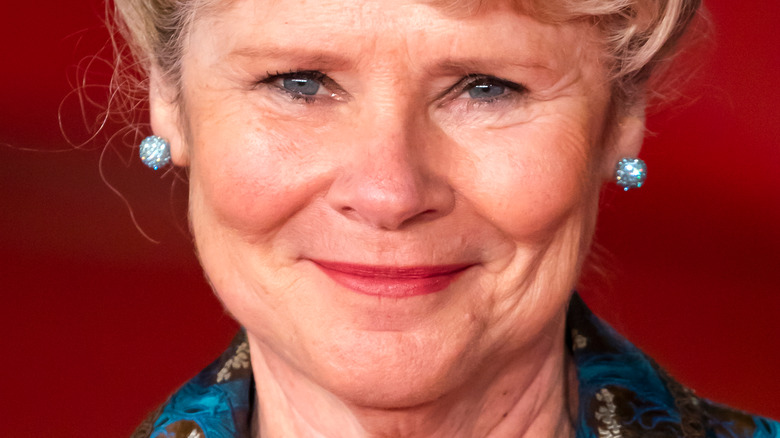 Imelda Staunton against a red wall