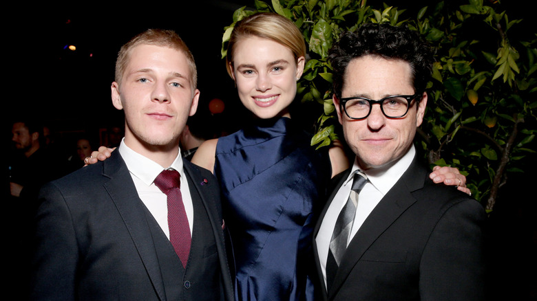 Daniel Webber, Lucy Fry, and J.J Abrams smiling at the 