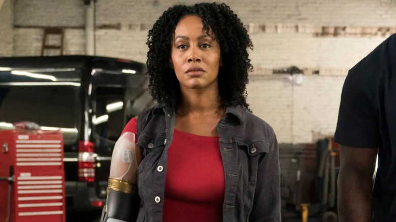 Misty Knight with her bionic arm next to Luke Cage