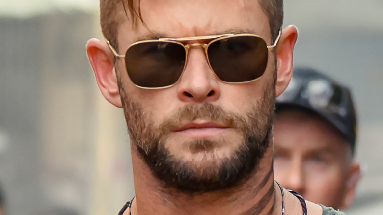 Tyler Rake in sunglasses frowning