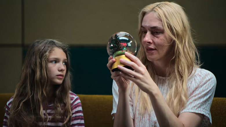 Jasmin holds up a snowglobe