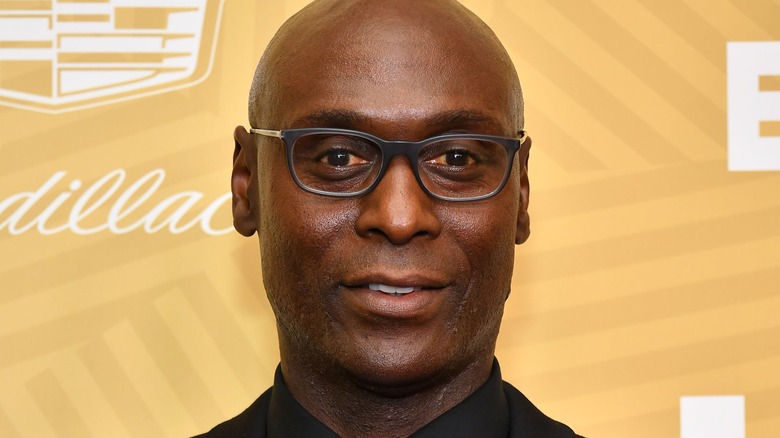 Lance Reddick wearing glasses