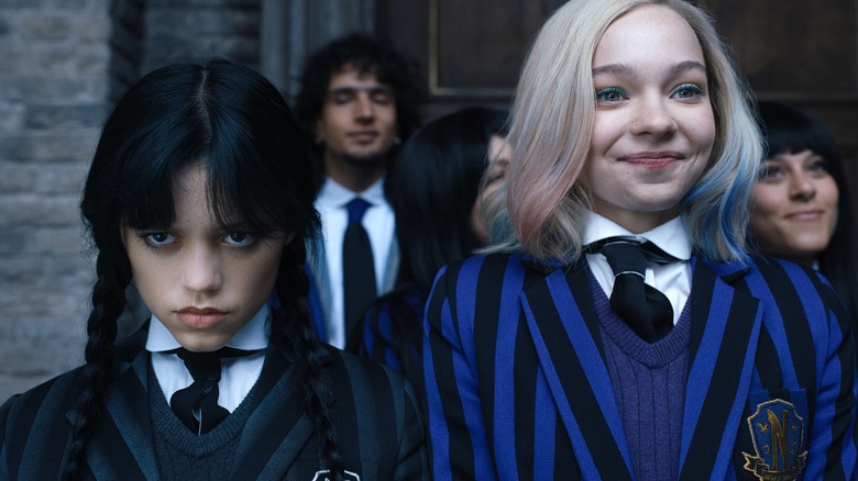 Wednesday and Enid look on