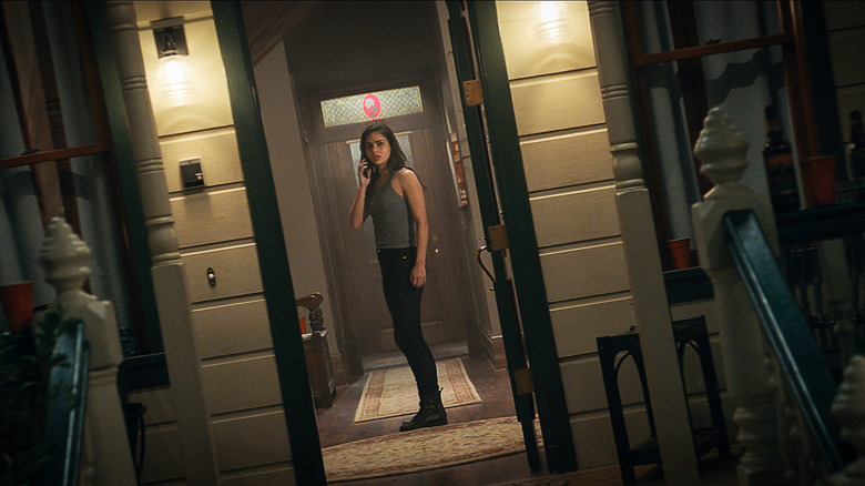 Sam standing in Stu's house