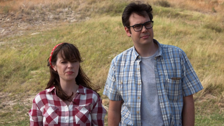 Jess and Robby standing on a windy hilltop