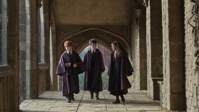 Ron Harry and Hermione walking down a hallway in Harry Potter and the Philosopher's Stone