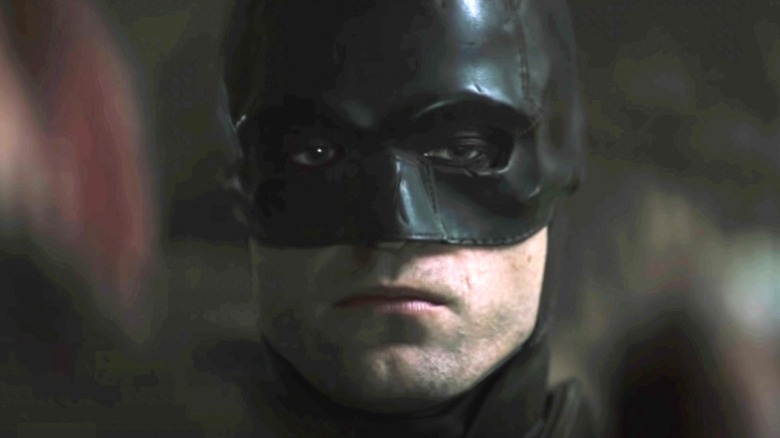 Robert Pattinson in Batman cowl looking serious