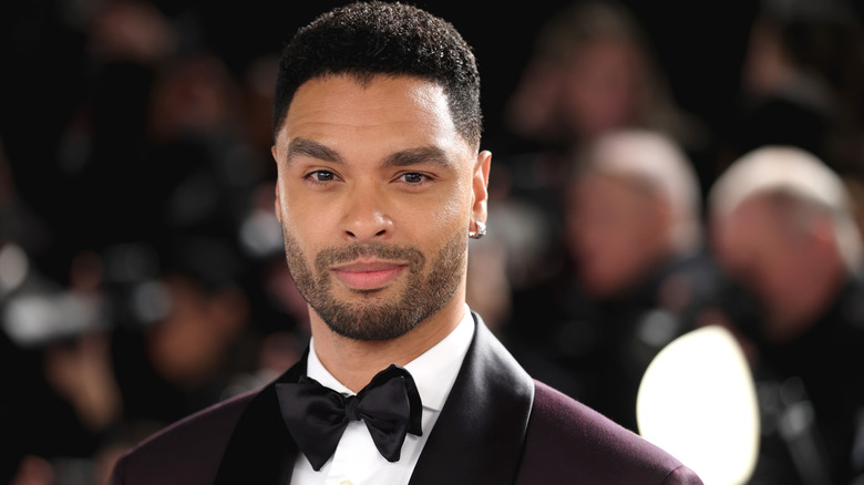 Close-up shot of actor Regé-Jean Page wearing a tuxedo and smirking