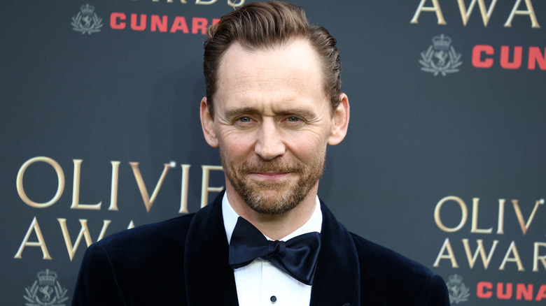 Close-up shot of actor Tom Hiddleston posing in a tuxedo at the Olivier Awards