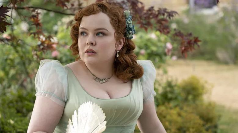 Penelope looks worried in a garden in "Bridgerton"