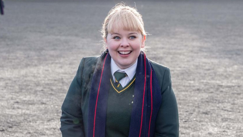 Clare smiling in her school uniform in "Derry Girls"