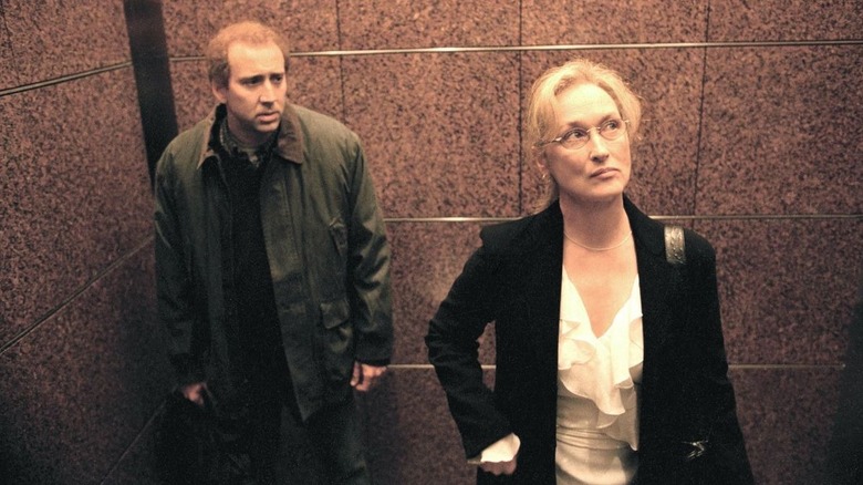 Charlie Kaufman lurking over Susan Orlean in an elevator in Adaptation (2002)