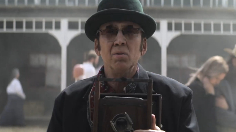 Ben holding a camera in Gunslingers (2025)