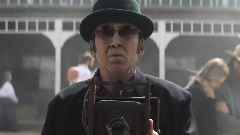 Ben holding a camera in Gunslingers (2025)