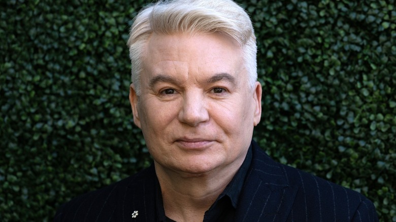 Mike Myers standing against green background