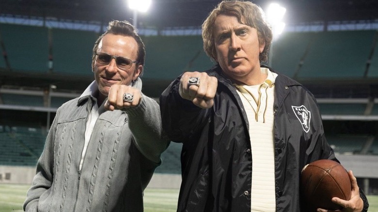 Nic Cage as John Madden and Christian Bale as Al Davis showing off their Super Bowl rings