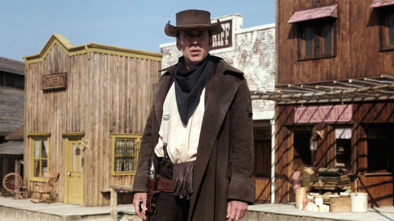 Nicolas Cage standing in town in "The Old Way"