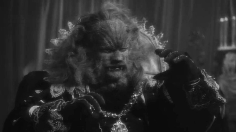 Beast holding his hands up in Beauty and the Beast (1946)