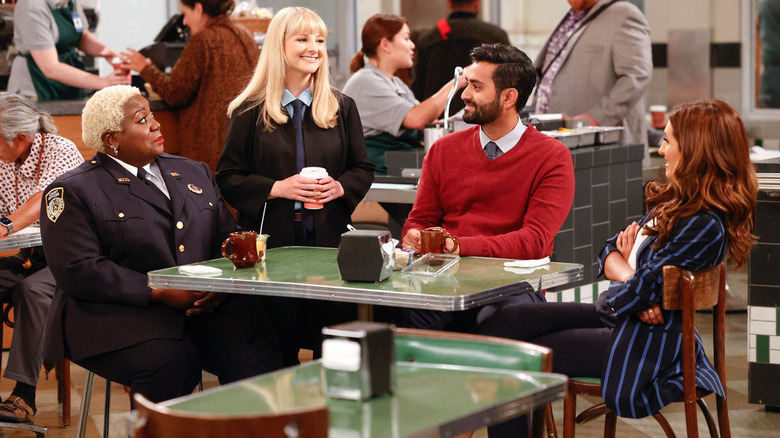Night Court revival cast gathered around restaurant table