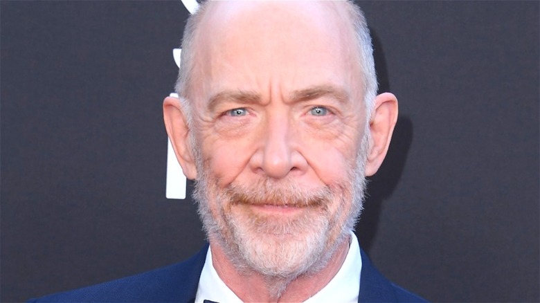 J.K. Simmons smiling in blue