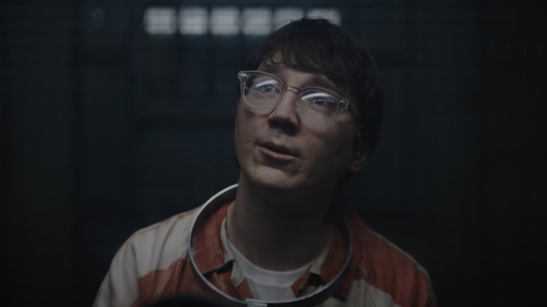 The Riddler wearing an orange and white prisoner uniform
