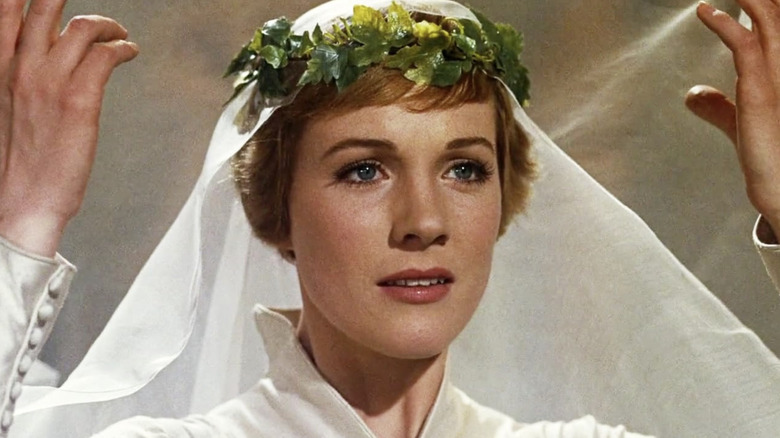 Maria smiling in white headpiece and dress in 