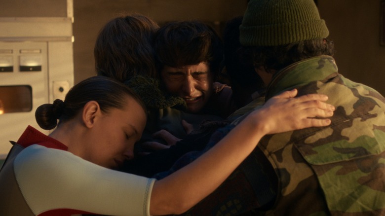 Eleven (Millie Bobby Brown) and friends hug Will (Noah Schnapp) on "Stranger Things"