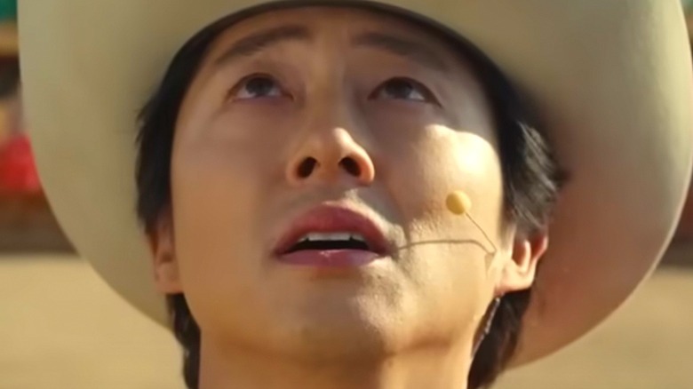 Steven Yeun looks at sky