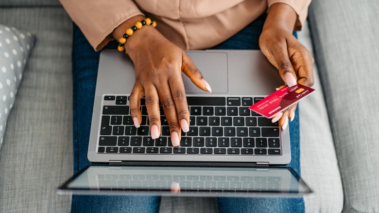 Someone using their credit card to shop online