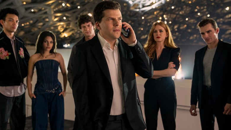 Atlas on the phone with Charlie; June, Bosco, Henley, and Jack behind him in Now You See Me, Now You Don't