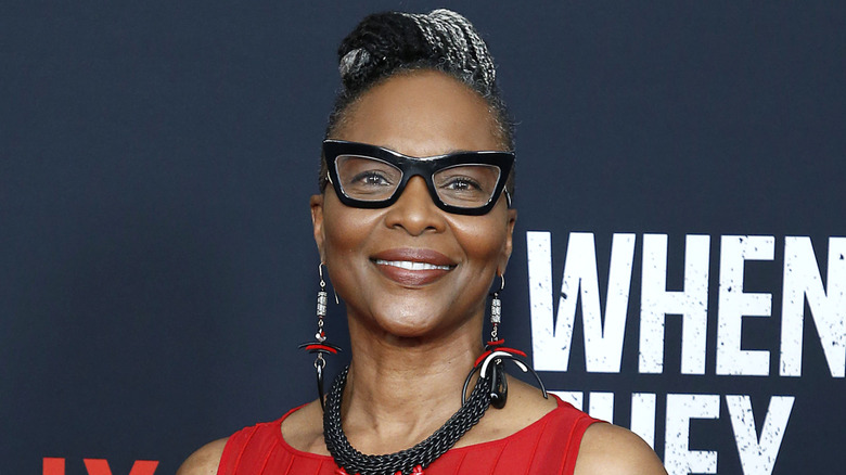 Suzzanne Douglas smiling in thick black glasses