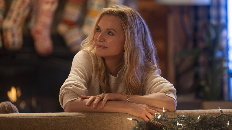 Claire resting arms on back of couch