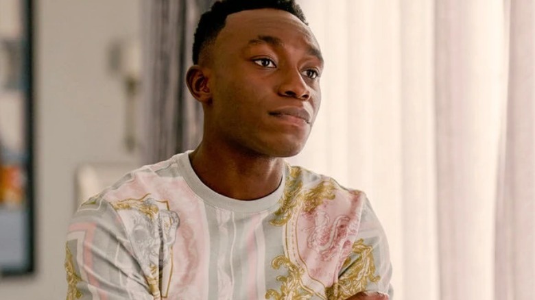 Carlton Banks standing by a window