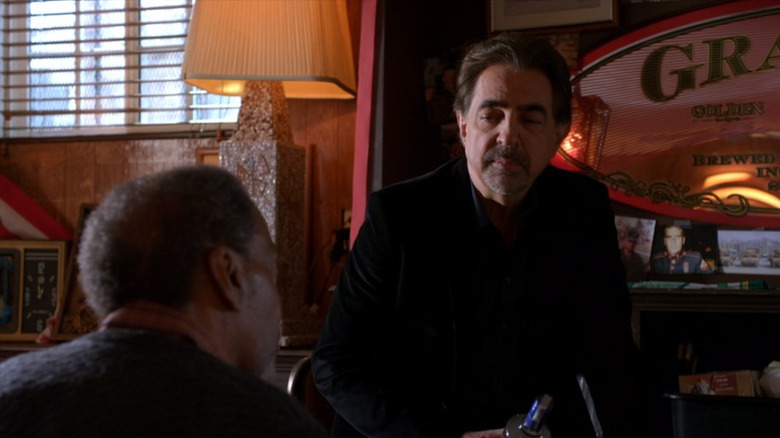 David Rossi looking at Harrison Scott black suit