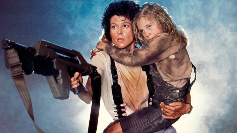 Ellen Ripley holds Newt tight while battling Xenomorphs in Aliens
