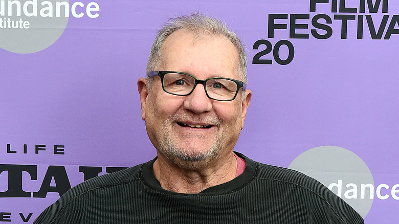 O'Neill stands in front of a poster