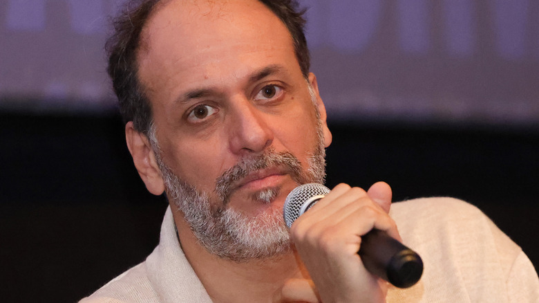 Luca Guadagnino talking into microphone