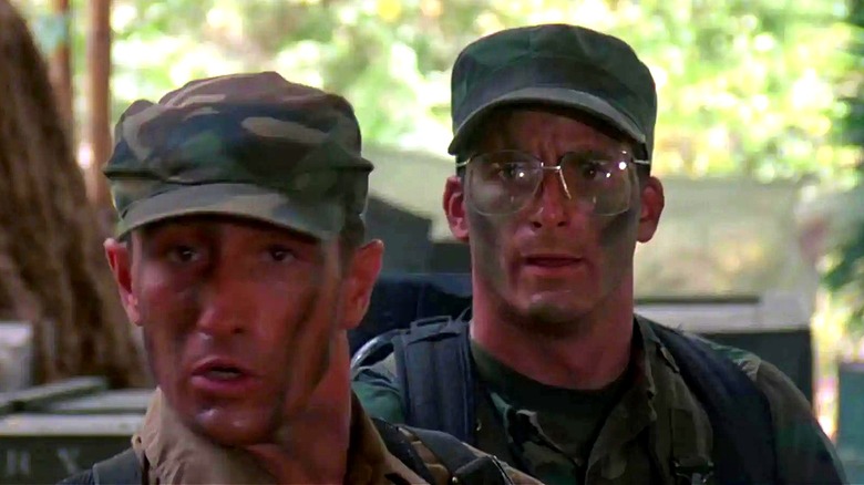 Poncho stands in front of Hawkins in 1987's Predator