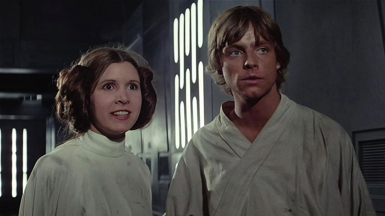 Leia and Luke standing together sweaty in "Star Wars" (1977)