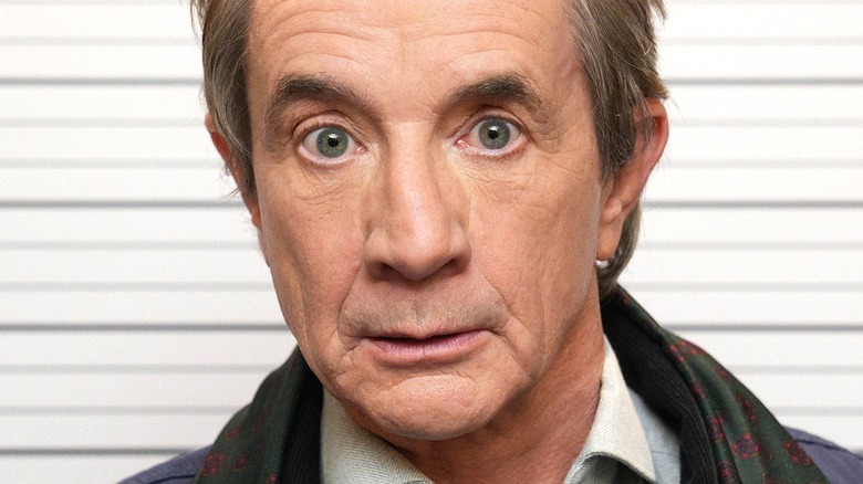Martin Short raises his eyebrows for a mugshot on Only Murders in the Building