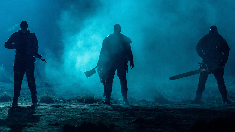 Cockroach, Butcher, and Crybaby standing ominously at night, weapons out, in "Onslaught" (2026)