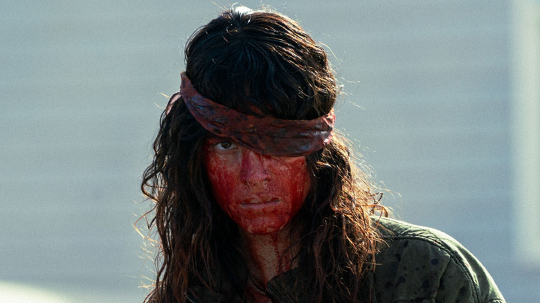 Celeste covered in blood with a bandana covering one eye
