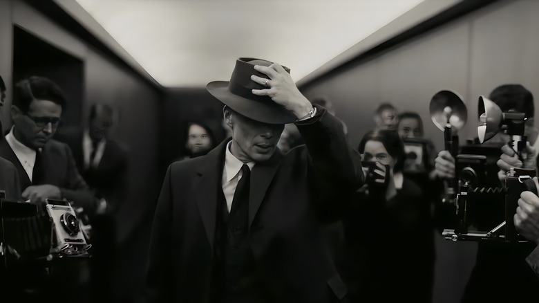 Oppenheimer walks through a paparazzi crowd