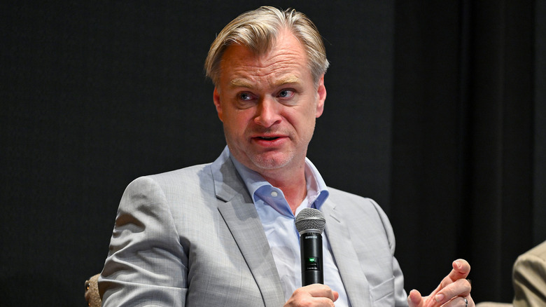 Christopher Nolan at event holding mic