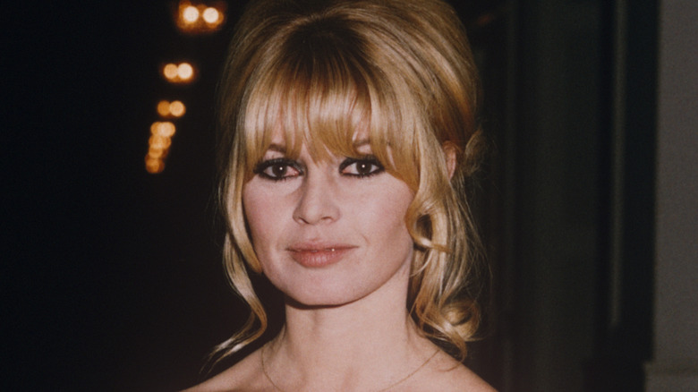 Brigitte Bardot holding a dog